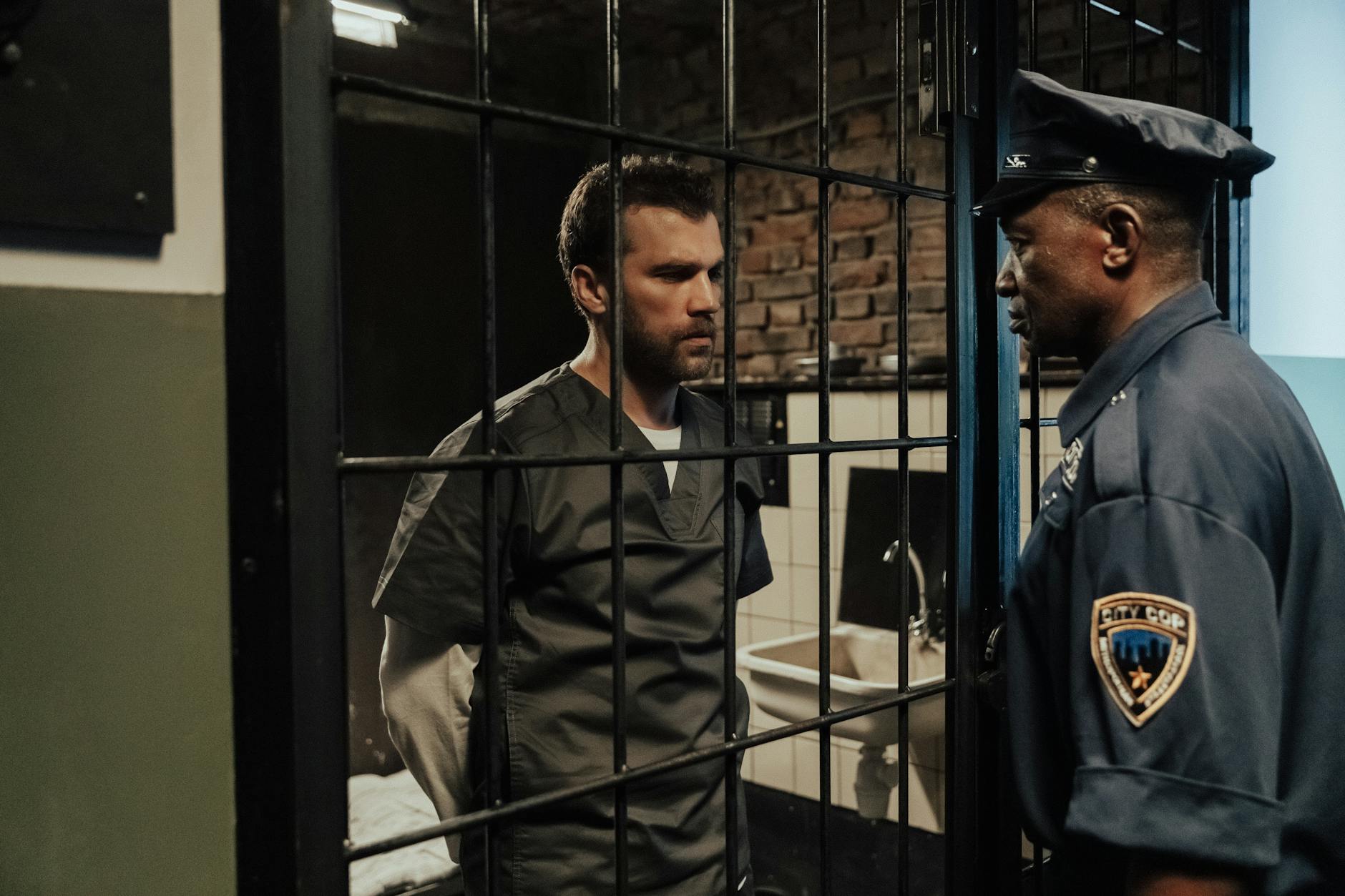 a policeman talking to a prisoner