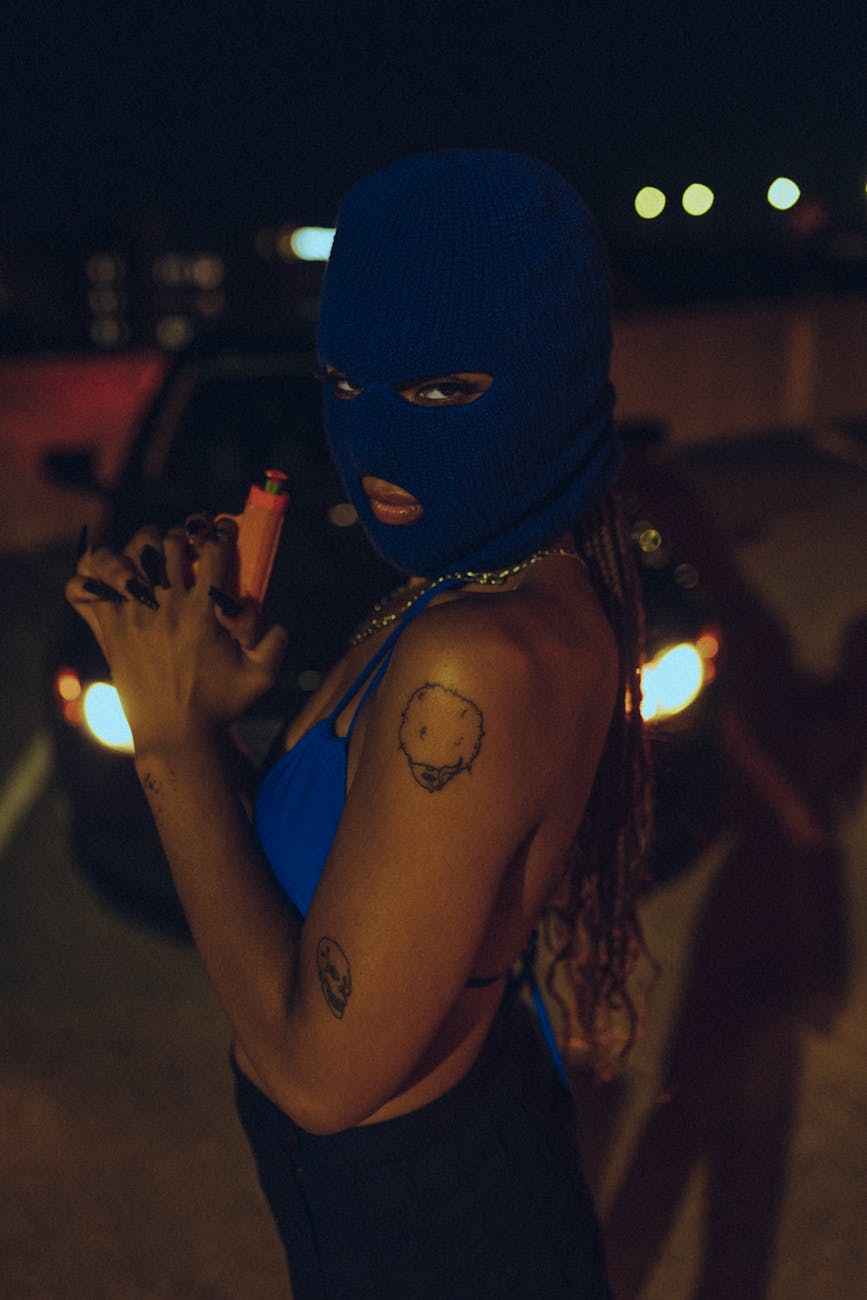 woman wearing a blue mask holding a toy gun