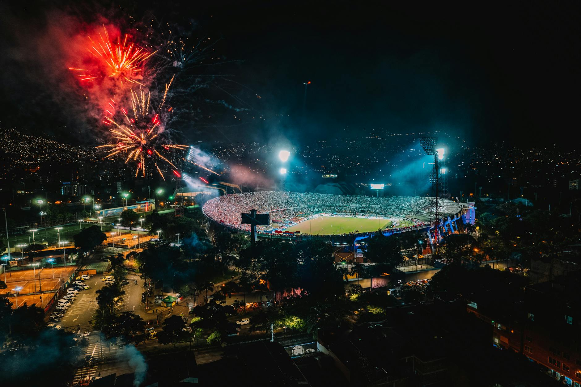 a fireworks near a stadium full of people during night time
