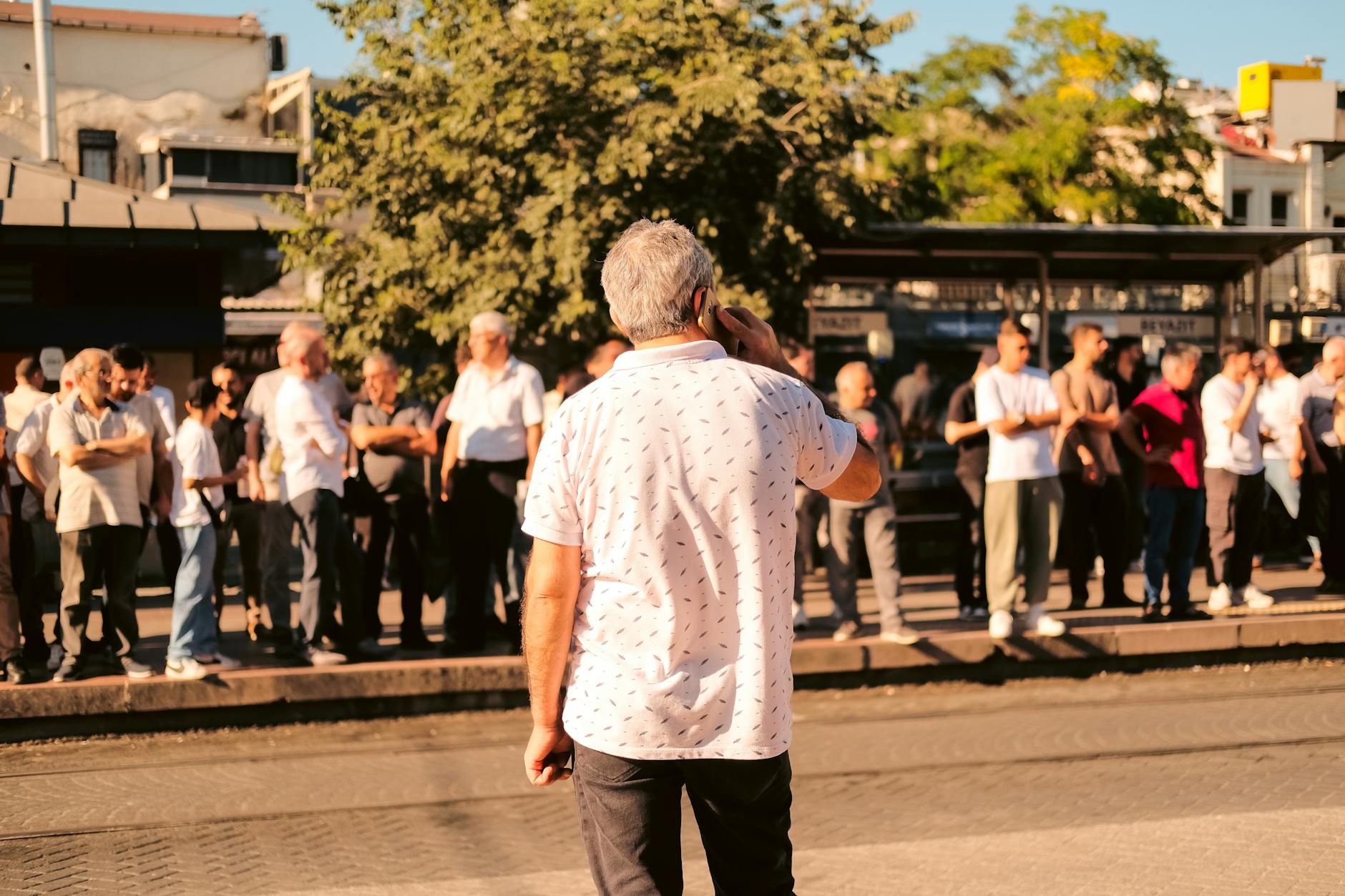 crowded urban bus stop with people waiting