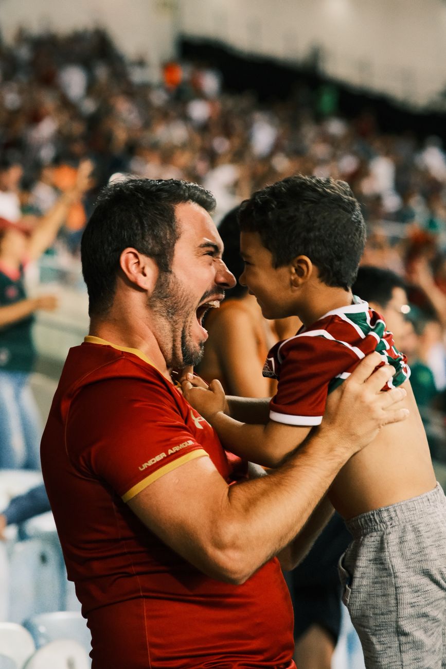father and son celebrating at a football game